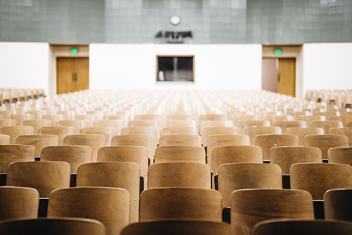 empty chairs in a school auditorium