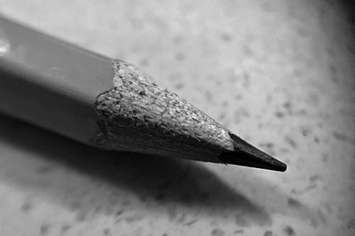 A black and white image of a recently sharpened no. 2 pencil..